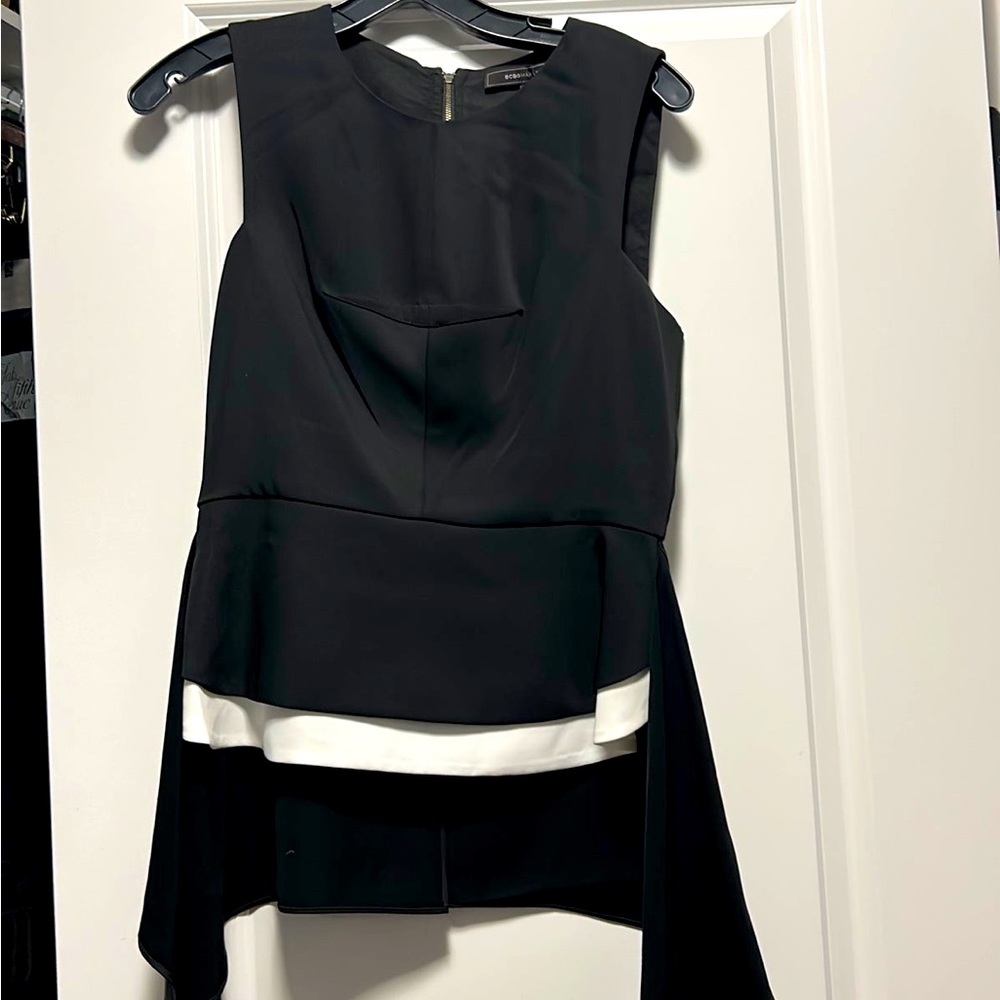 BCBG black and white peplum top with zipper back. VGUC no damage
